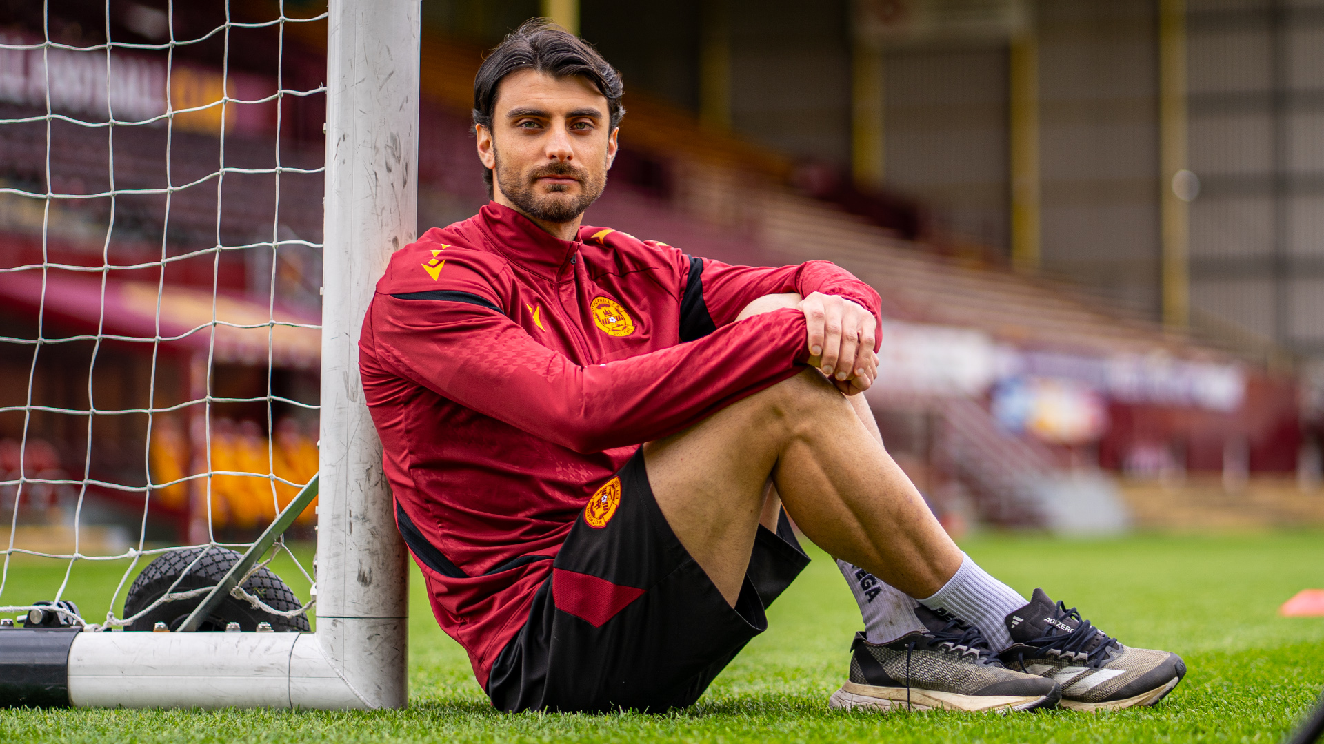 Johnny Koutroumbis ahead of Hibernian